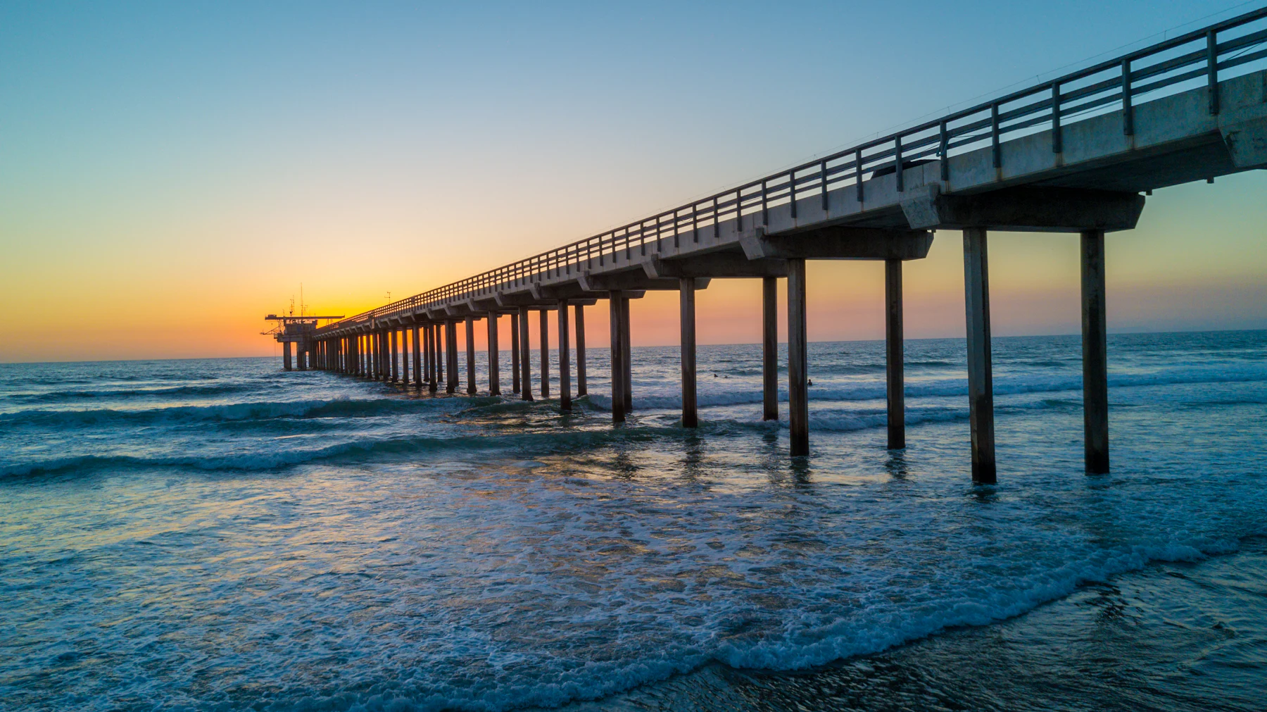 The Ocean Beach pier stretching into the Pacific at sunset in San Diego