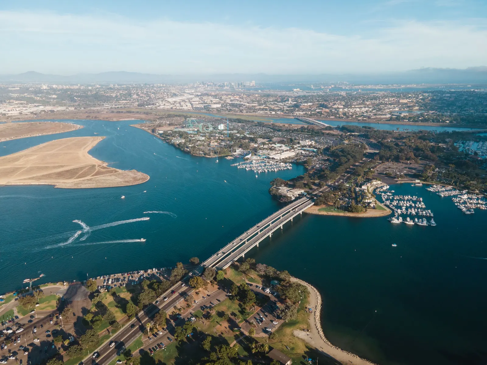 Aerial view of Mission Bay with a long bridge, marinas and sandy islands