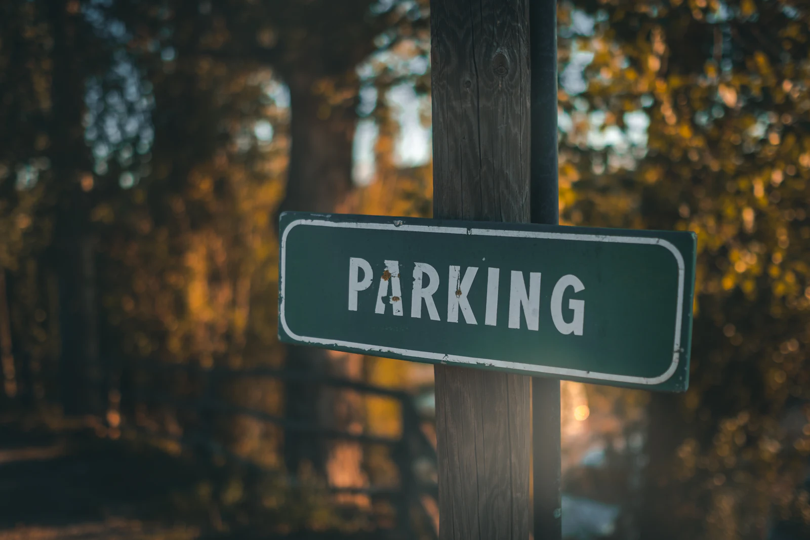 A parking sign on a wooden post