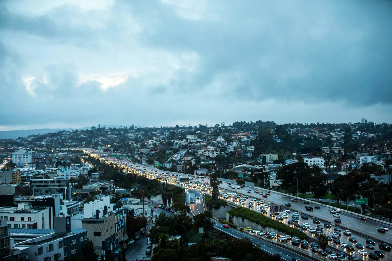 Heavy rush-hour traffic on a San Diego freeway at dusk, seen from above